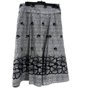 This is a one of a kind knee length black and white floral skirt. Size 2.